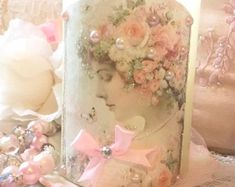 an elaborately decorated cake with pink flowers and pearls