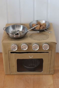 an old stove with two pans on top of it