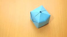 an origami ball sitting on top of a wooden table