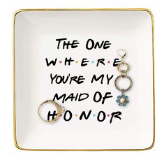 a plate with two rings on it that says the one where you're my maid of honor