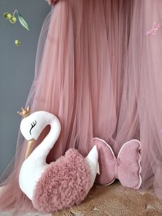 there is a stuffed swan next to some pink tulle