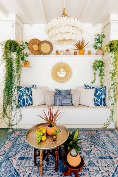 a living room filled with furniture and plants