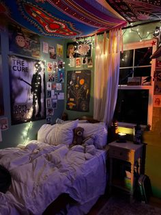 a bedroom decorated with posters and lights