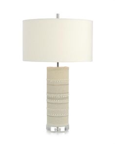 a table lamp with a white shade on it