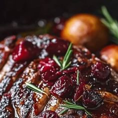 meat with cranberry sauce and rosemary garnish on it's side