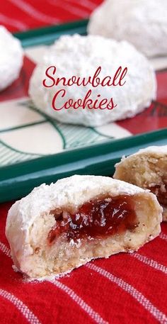 snowball cookies with jelly inside on a red and white tablecloth