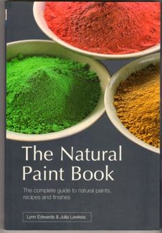 the natural paint book is being held up