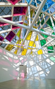 a room with many different colored glass pieces hanging from it's ceiling and floor