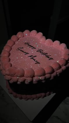 a birthday cake with pink frosting and sparkles