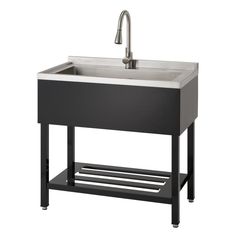 a black sink with a metal faucet on the bottom and an open shelf underneath it