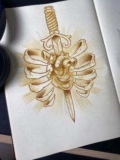 a drawing of a dagger and heart on a book