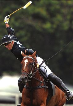 a man riding on the back of a brown horse