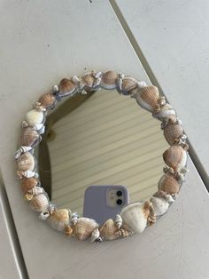 there is a mirror that has shells on it