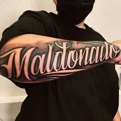 a man with a black mask on his face is wearing a tattoo that reads maltonians