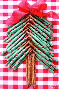 a christmas tree made out of pretzels and crackers on a checkered tablecloth