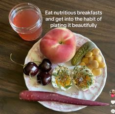 a plate with fruits and vegetables on it next to a cup of tea, an eggplant