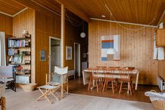 a living room with wooden walls and flooring