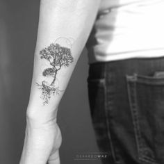 a person with a tree tattoo on their arm