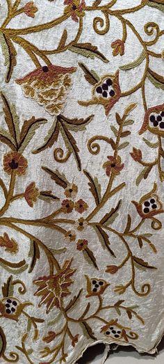 an intricately designed piece of cloth with gold and red flowers on it's edges