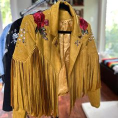 New Custom Made/ Soft Faux Suede Fringe Jacket/ Open Closure/ Swarovski Crystals/ Pearl & Gold Studs/ Butterfly & Rose Appliqu/ Detailed Design Under The Fringe On The Back Size: Medium *Never Been Worn Please Note This Particular Jacket Has Items On It That Can Not Be Purchased Again. Spring Embellished Leather Jacket With Long Sleeves, Spring Embellished Gold Outerwear, Embellished Gold Outerwear For Spring, Gold Embellished Outerwear For Spring, Rodeo Clown, Fringe Coat, Cowboy Fashion, Groovy Clothes, Cowboy Jacket