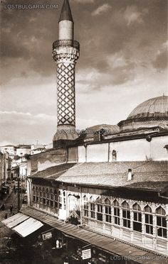 an old black and white photo of a tall building