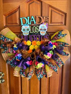 a colorful wreath that says diade los muertos on it's front door