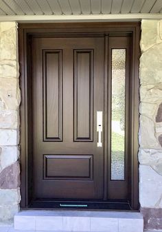 a brown front door on a stone house