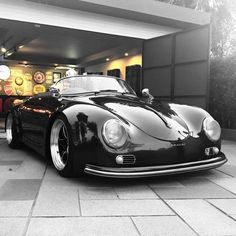 a black sports car parked in front of a building