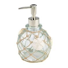 a glass soap dispenser with a starfish design on it's side