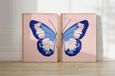 two blue and white butterflies on pink canvases in front of a wall with wood flooring