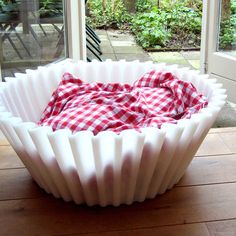 a large white bowl sitting on top of a wooden table