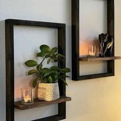 two wooden shelves with candles and vases on them against a white wall next to each other