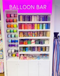 a display case filled with lots of different types of sewing thread and spools