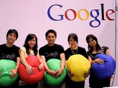 four people are holding large bean bags in front of their faces and smiling at the camera