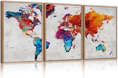 three colorful world maps are displayed on a wall