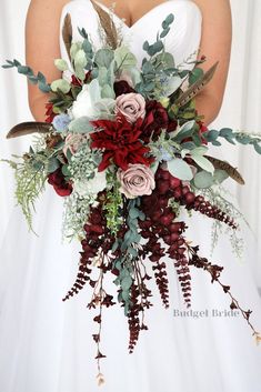 a bridal holding a bouquet of flowers and greenery