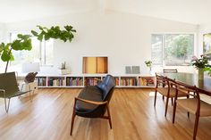 a living room filled with furniture and a book shelf