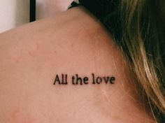 the back of a woman's neck with an all the love tattoo on it