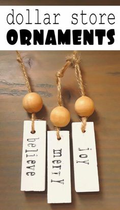 three tags with the words dollar store ornaments hanging from twine strings on a wooden table