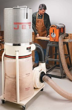 a man in an industrial shop working on a machine that is powered by a blow dryer