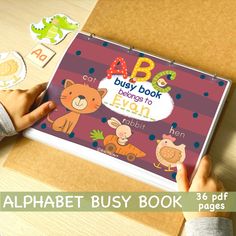 the alphabet busy book is being held by a child