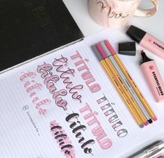 a notebook with some writing on it next to two pencils and a cell phone