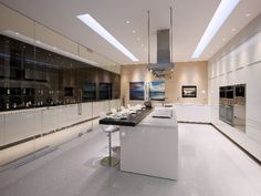 a large kitchen with white cabinets and counter tops