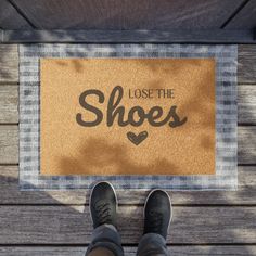 someone standing in front of a door mat that says, lose the shoes