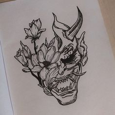 a drawing of a skull with flowers in it's mouth and horns on its head