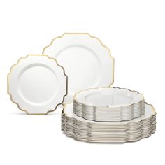 a stack of white and gold dinner plates