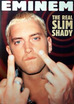 a man with blonde hair and blue eyes making the middle finger sign for two fingers