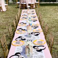 a long table is set up with mickey mouse plates and place settings for an event