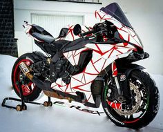 a white and red motorcycle parked in the snow