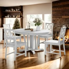 a white table and chairs in front of a fireplace